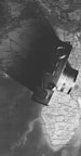 A vintage camera is placed on a monochrome world map, covering parts of Africa and Europe. The camera casts a shadow on the map, creating a dramatic contrast. The focus is on the interplay of light and shadow, highlighting the camera's lens and dials.
