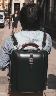 A model wearing a sleek backpack in an urban environment.