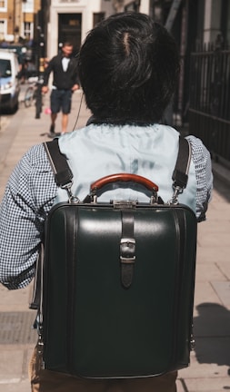 A commuter carrying the rugged backpack on a busy city street.