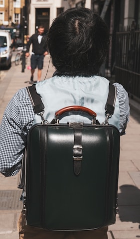 A commuter carrying the backpack in an urban setting.
