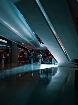 person walking beside escalator