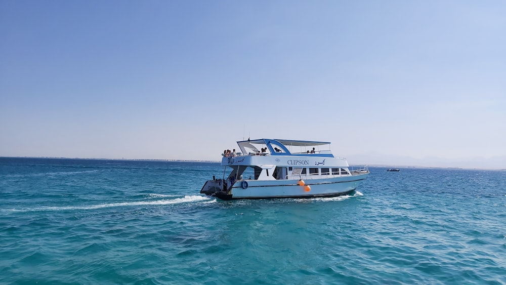 white yacht floating on blue ocean