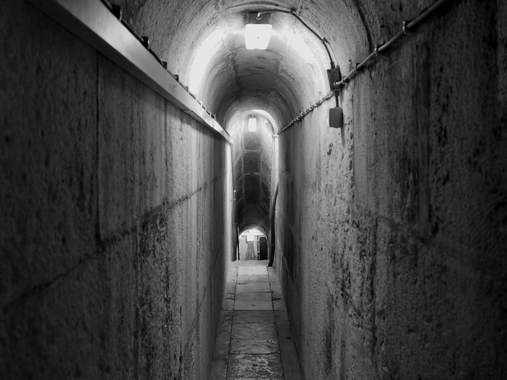 grayscale photography of a narrow archway