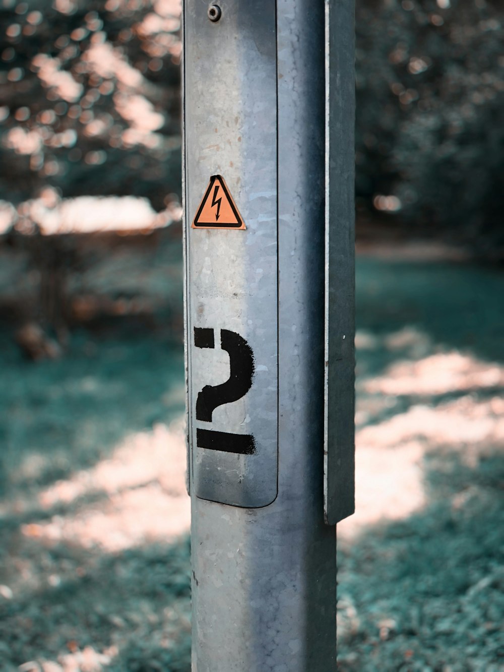 a metal pole with a street sign on it