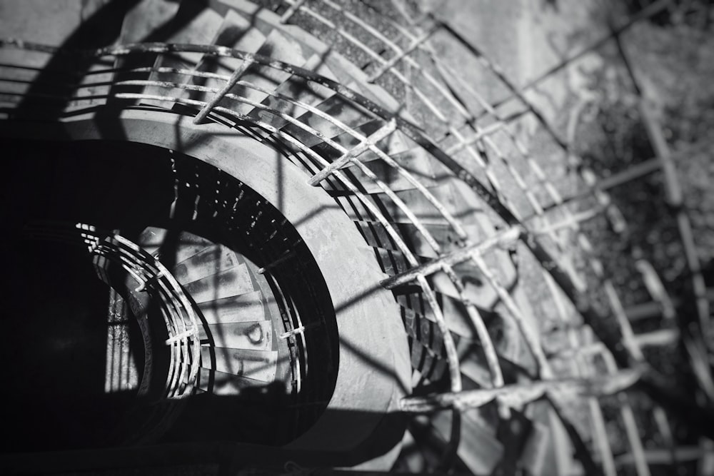 a black and white photo of a spiral staircase