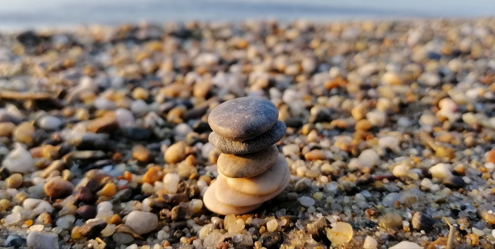 selective focus photography of stone cairn