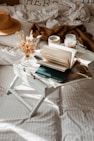 white book page on white wooden over bed table