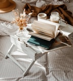 white book page on white wooden over bed table