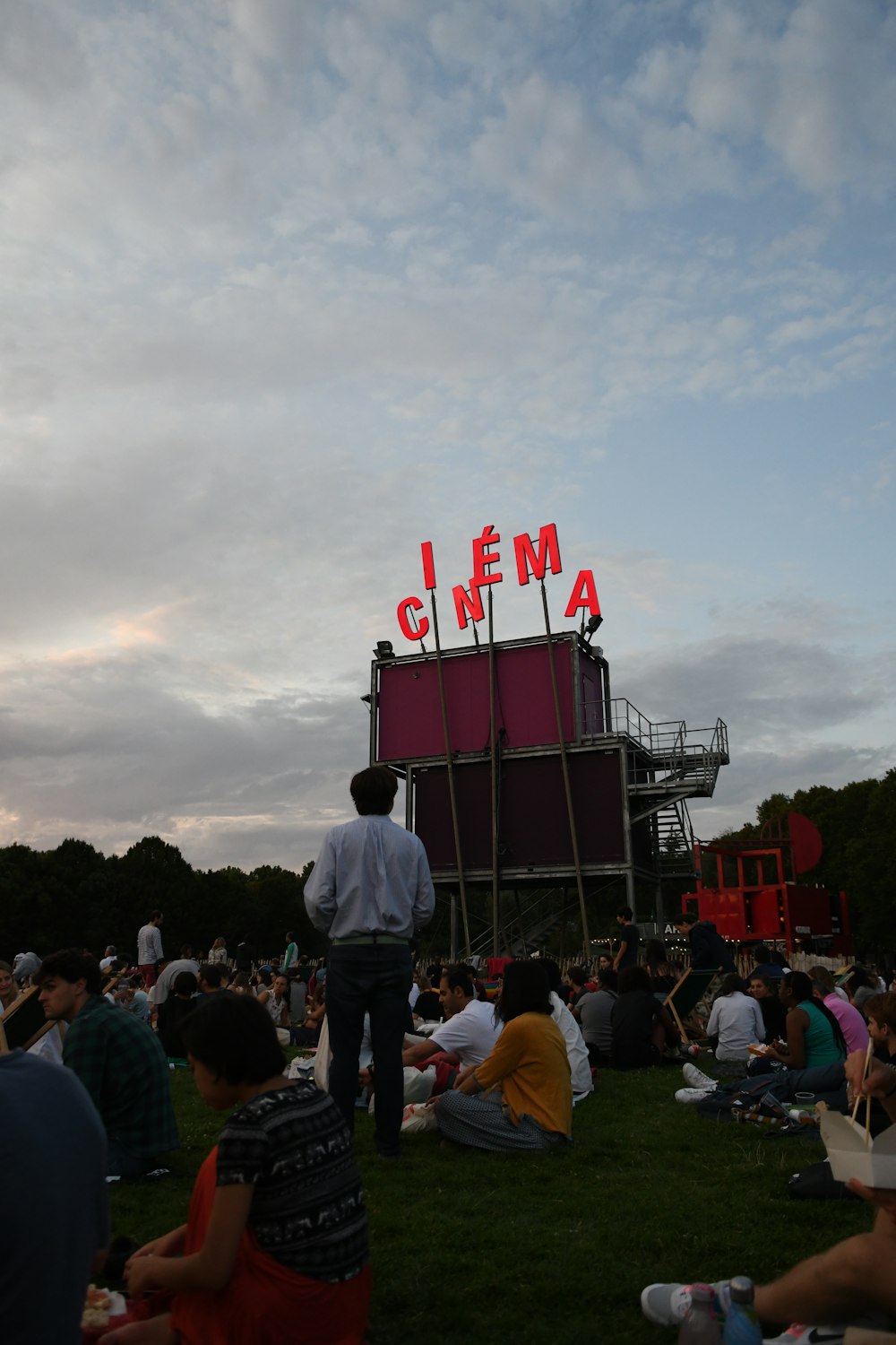people sitting on field near cinema stage
