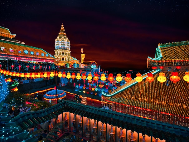 An ancient temple adorned with colorful lanterns and stone steps.