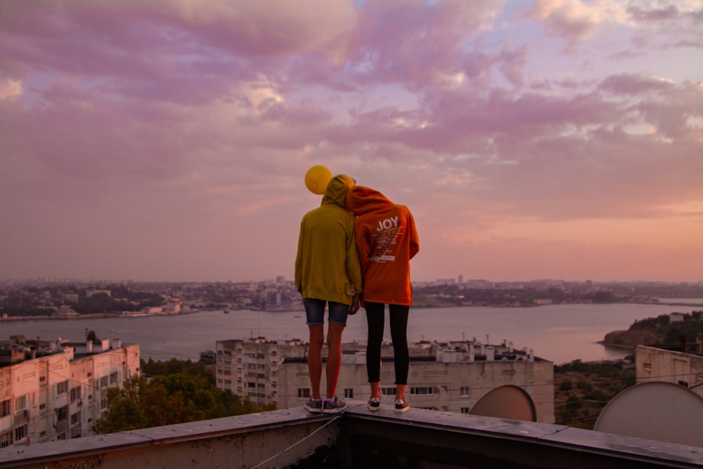 two person standing on rooftop