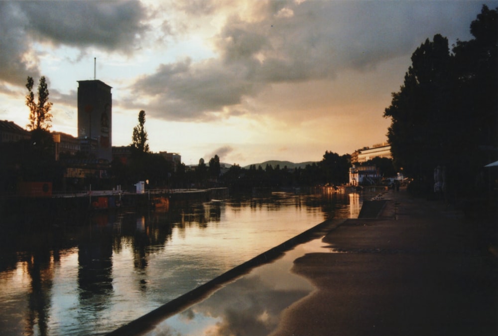 silhouette of building near water during sunrise