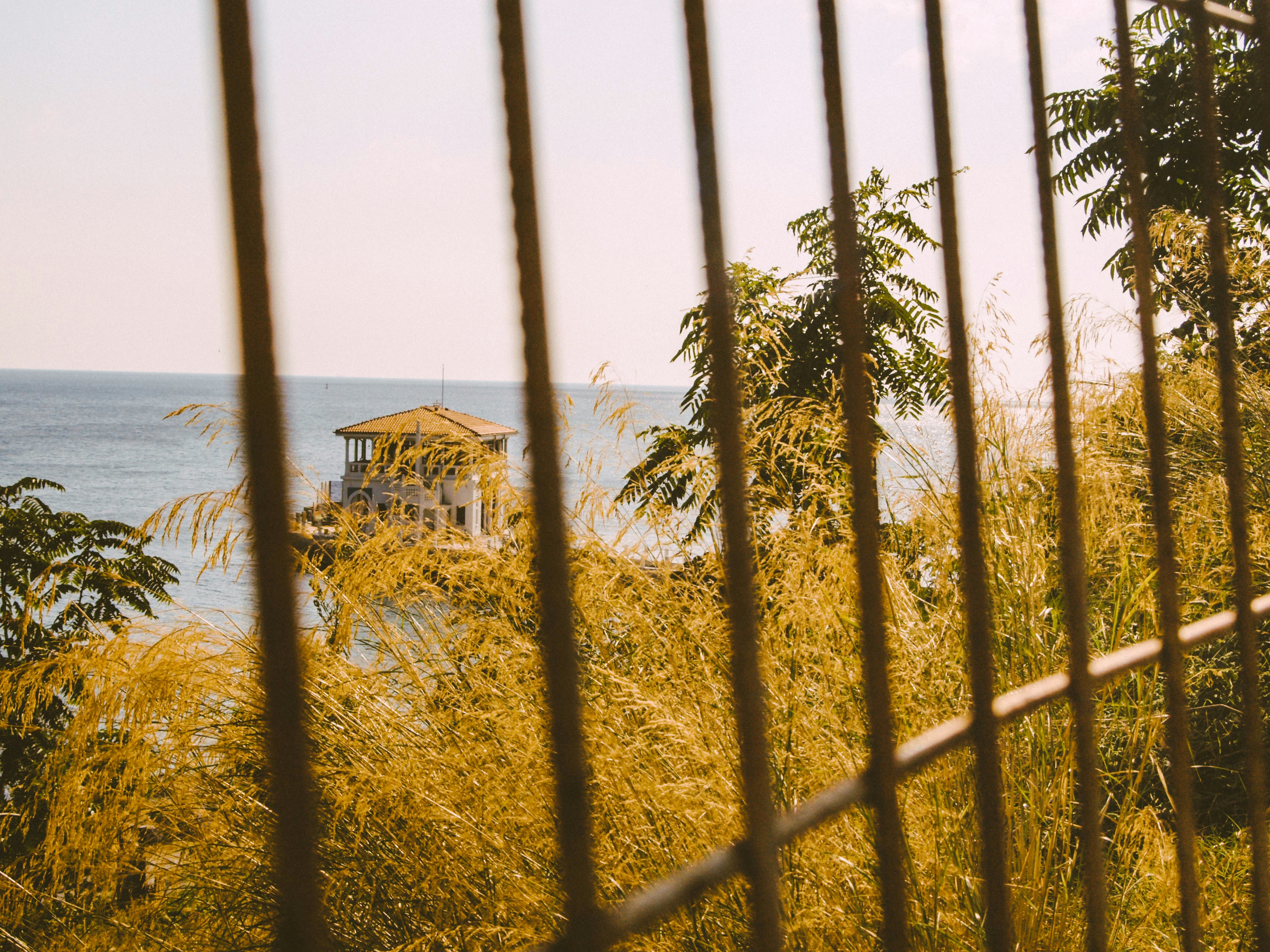 a gazebo sitting on top of a lush green hillside