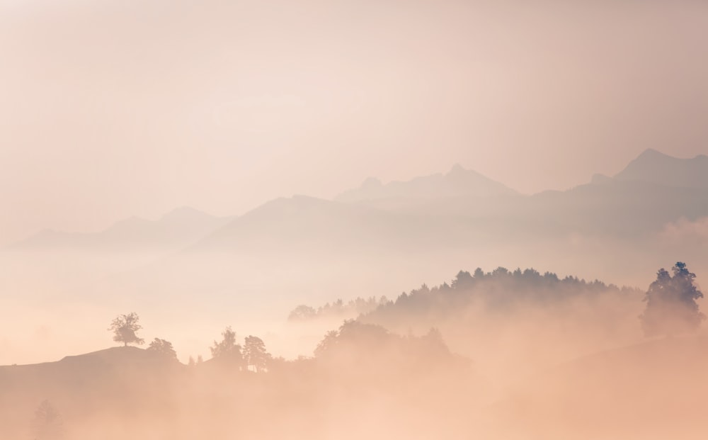 clouds covering mountains during daytime