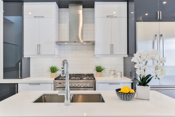 A bright clean kitchen with white cabinets 