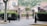 A professional security guard standing at the entrance of a bustling event.