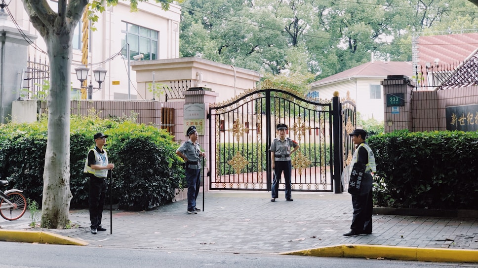 Security guard standing alert at a commercial building entrance.