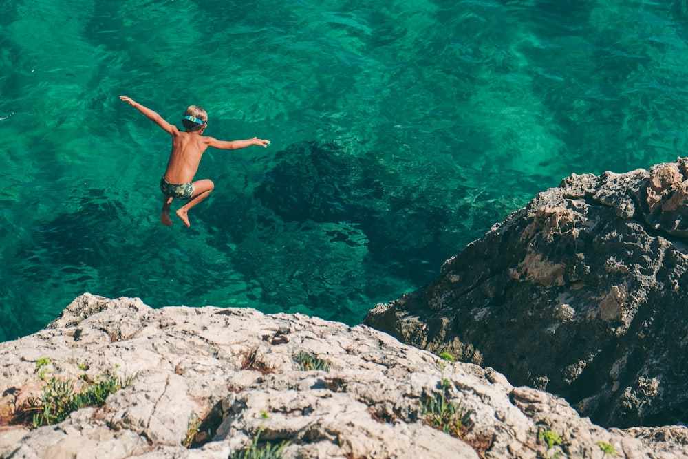 boy diving on sea