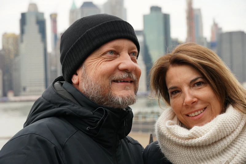 Older couple in coats by the water