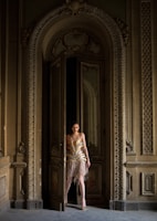 woman standing beside opened door