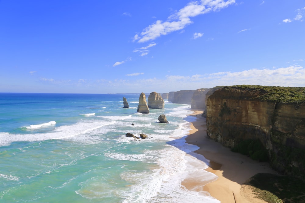 rock formation on seashore at daytime