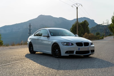 white BMW coupe on road