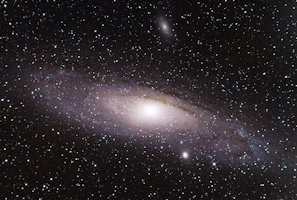 A swirling galaxy with bright stars glowing against a dark sky.