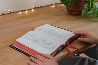 Cover of a warm, inviting book titled 'Autism Hearts & Hacks' resting on a wooden table with soft natural light.