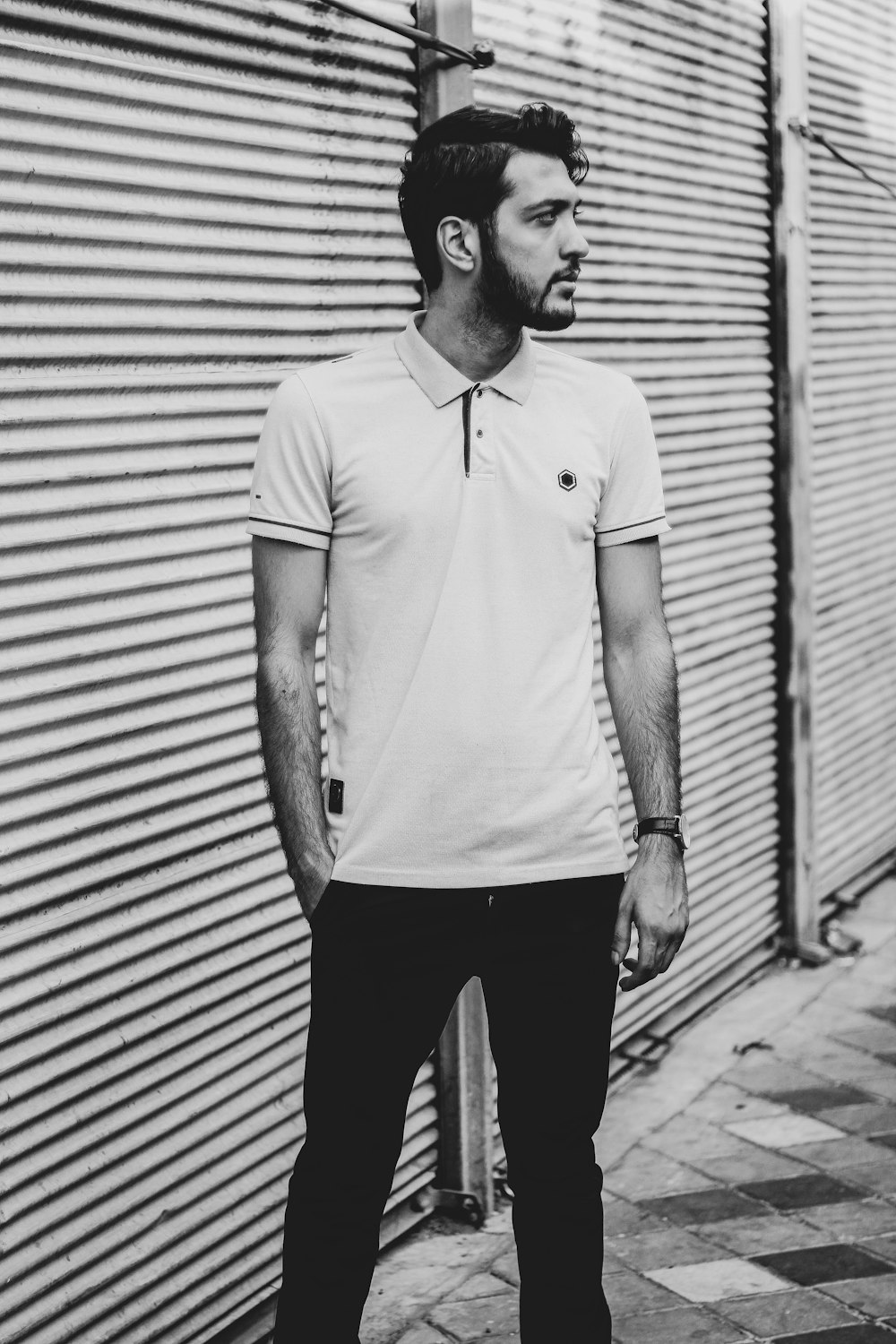 grayscale photo of man wearing polo shirt