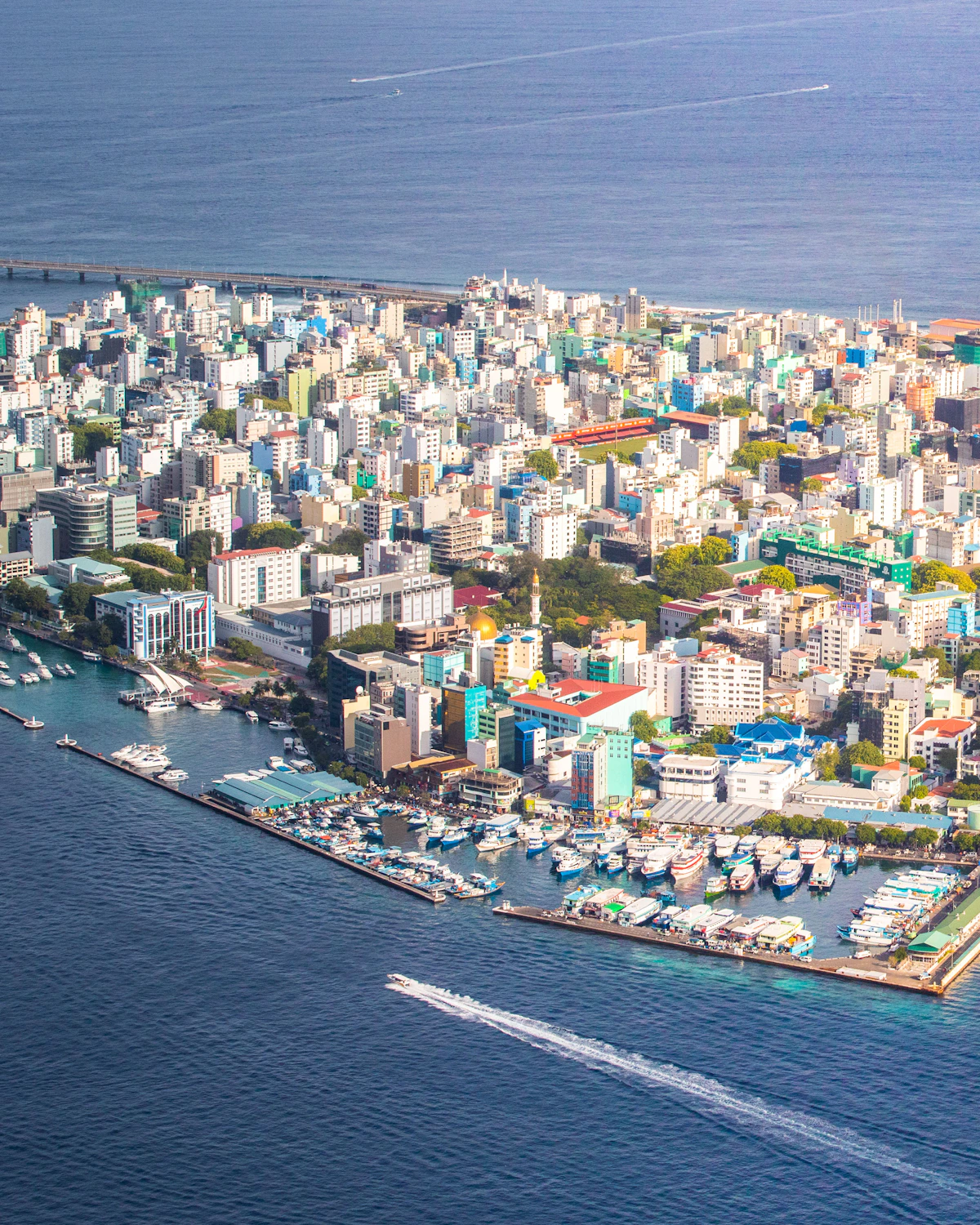 Malé's waterfront, boats and dense city blocks viewed from above