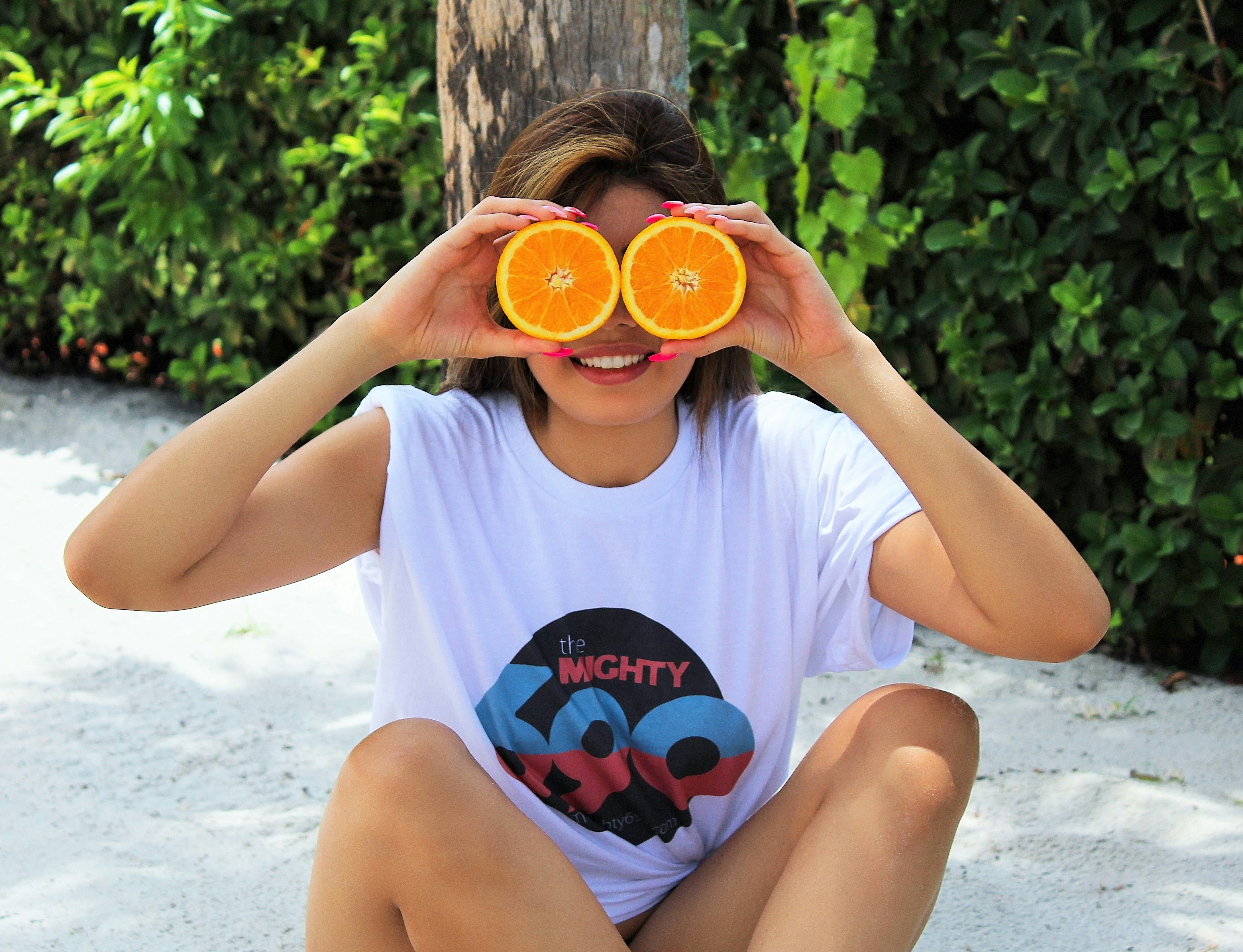 woman holding orange slices