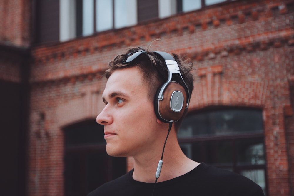 man using black and gray corded headphones