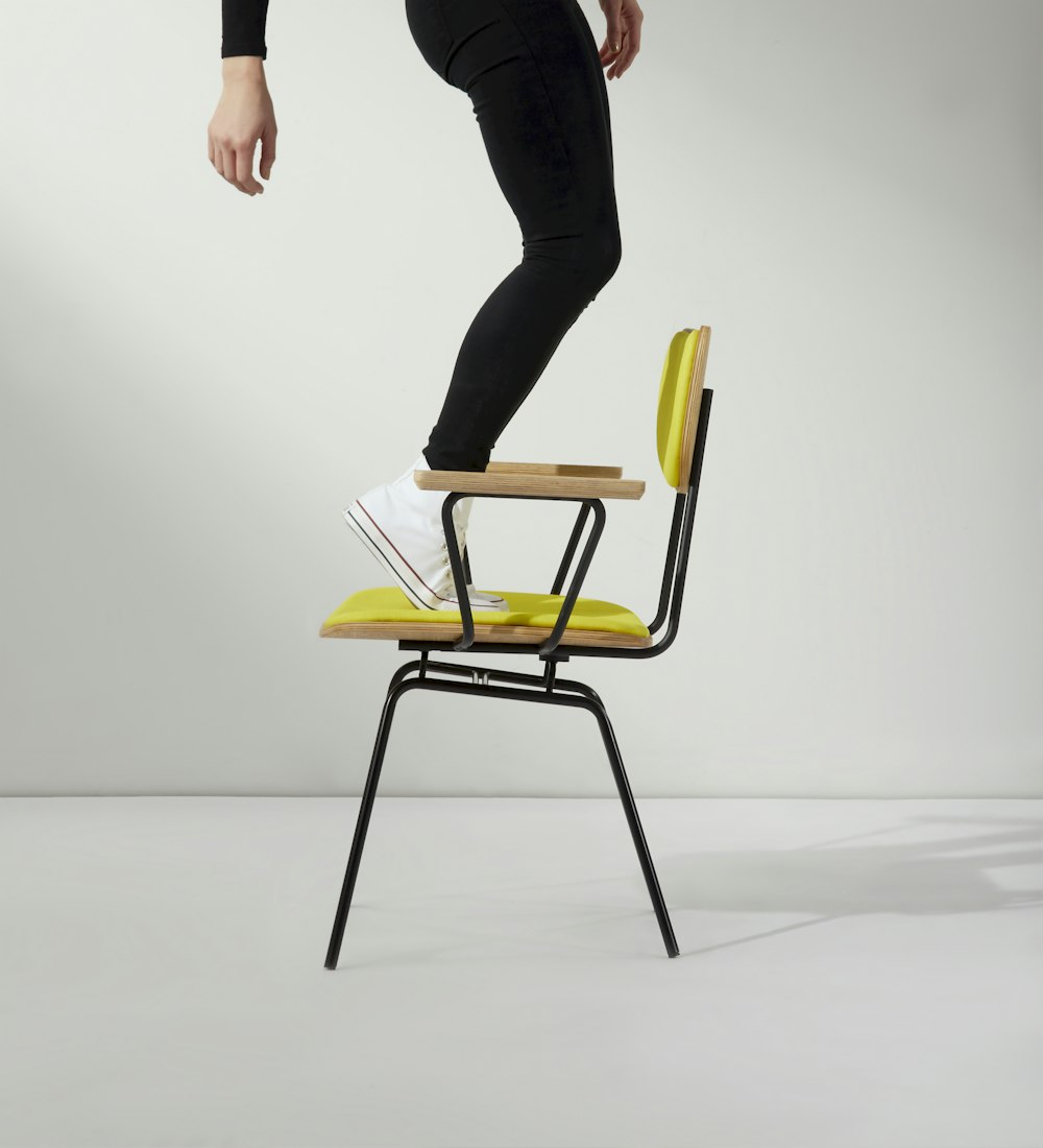 person standing on chair photo – free chair image on unsplash