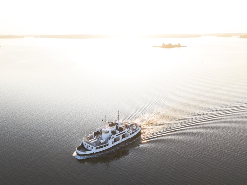 white cruise ship on calm body of water