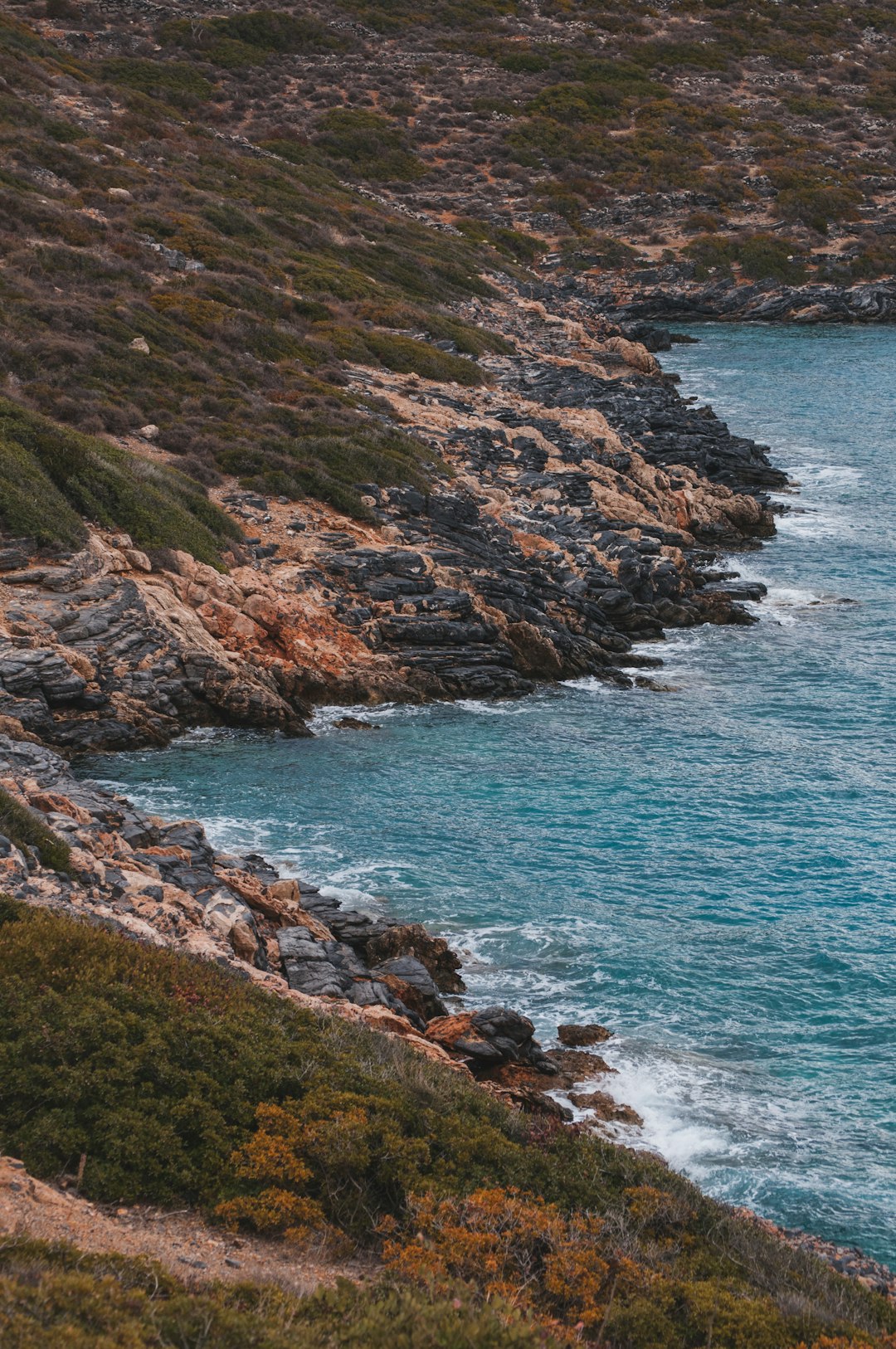 beach cliff viewing blue sea during daytime