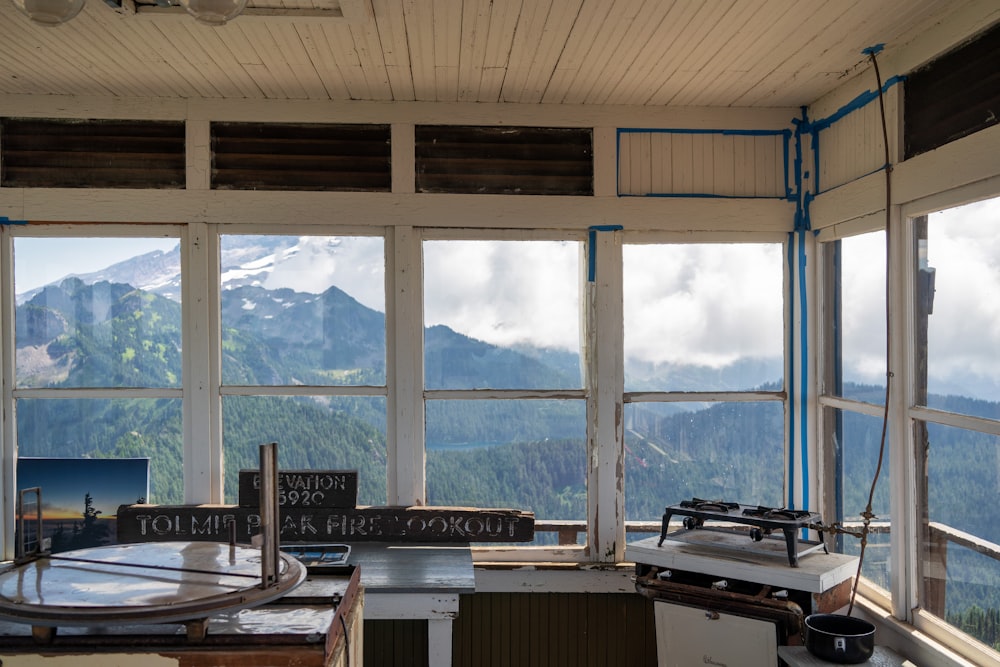 white wooden table inside building viewing mountain outside during daytime