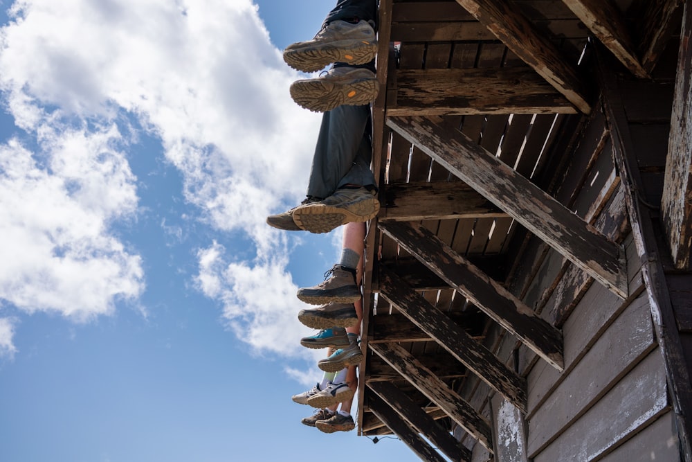 person sitting on wooden dock at daytime