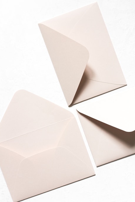 three white mail envelops