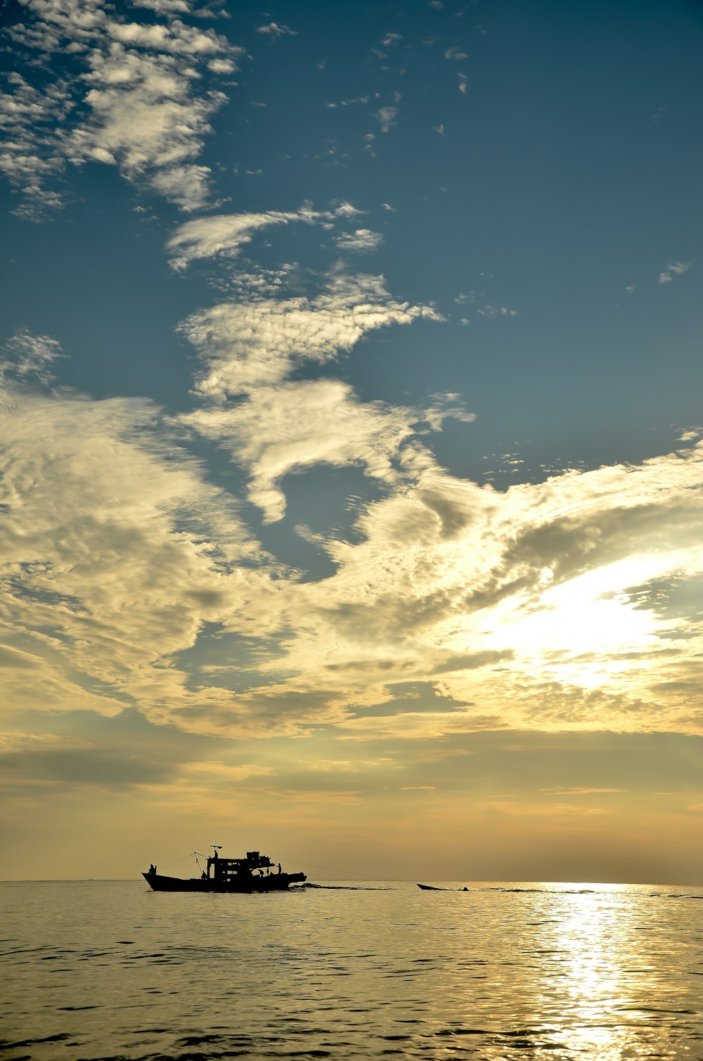 boat floating on the ocean during day