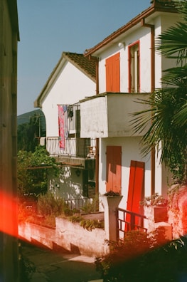 An exterior view of a beautifully painted house under sunlight.