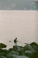 Close-up of a swimmer adjusting her colorful swim cap near the shore