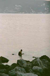 Close-up of a swimmer adjusting her colorful swim cap near the shore