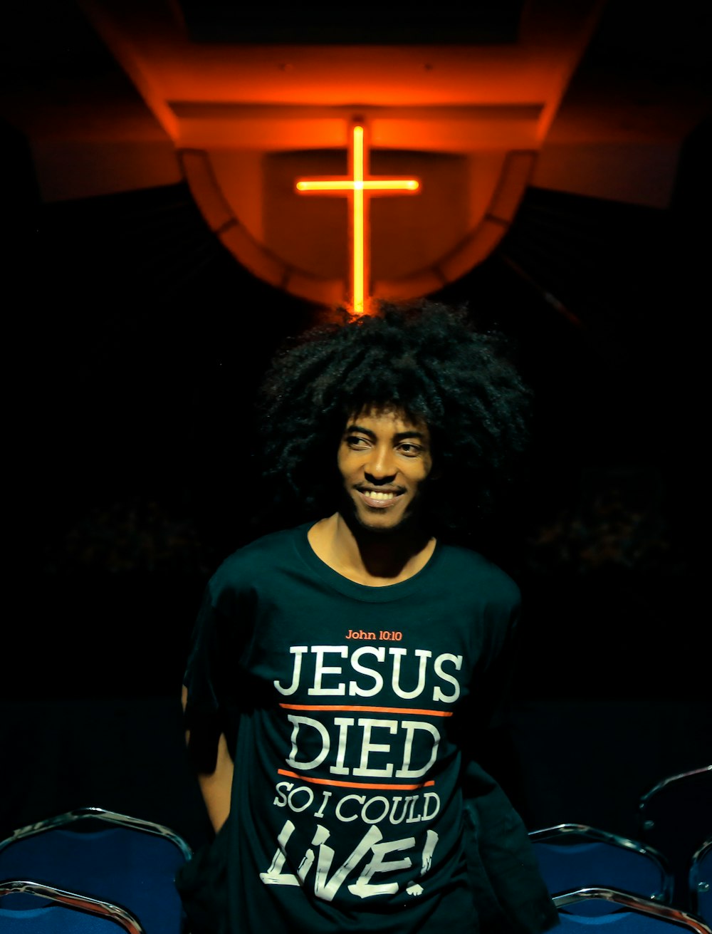 smiling man wearing black Jesus Died so I Could Live-printed shirt