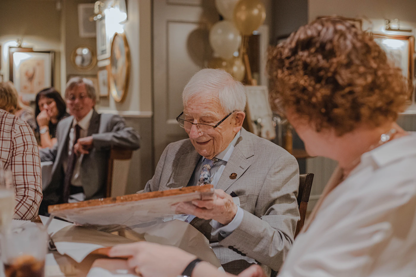 Older couple reviewing paperwork with an advisor at a table