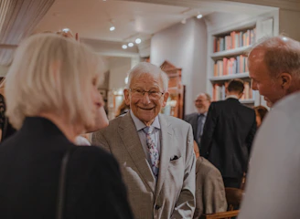 smiling man wearing suit standing beside man