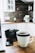 A cozy kitchen scene with a minimalist mug filled with steaming coffee on a wooden table.