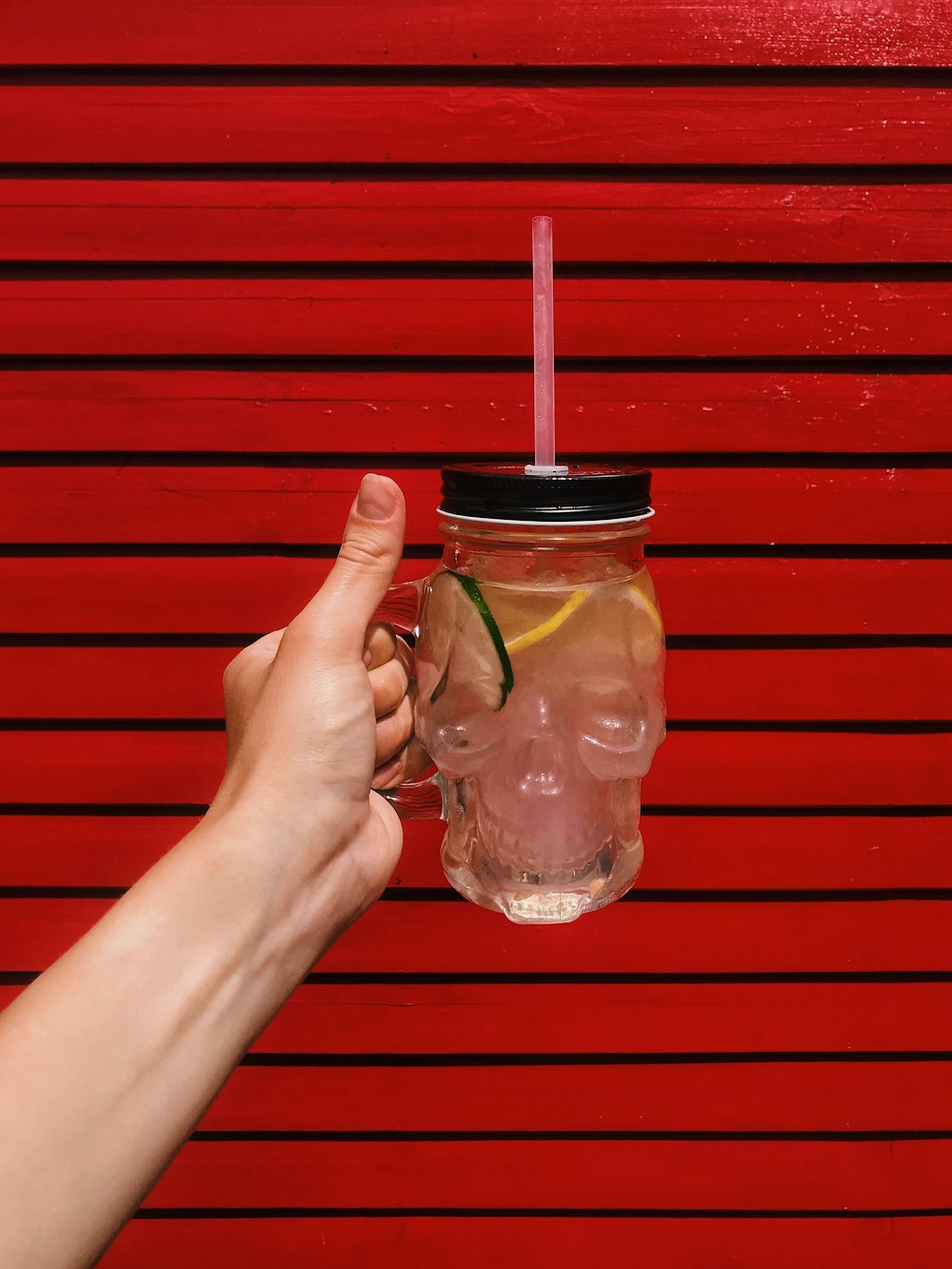 person holding glass jar