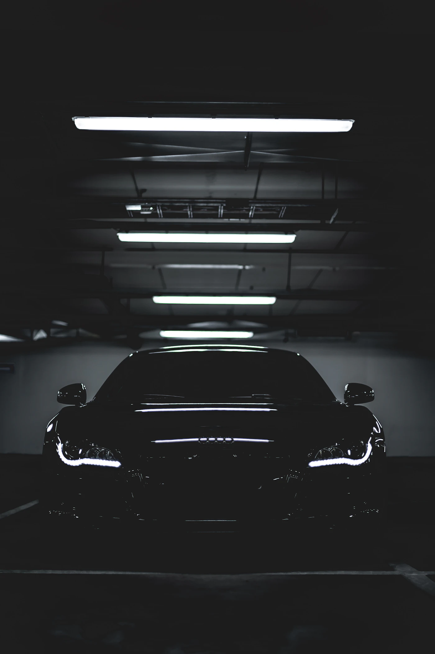 A freshly detailed car in a dark bay