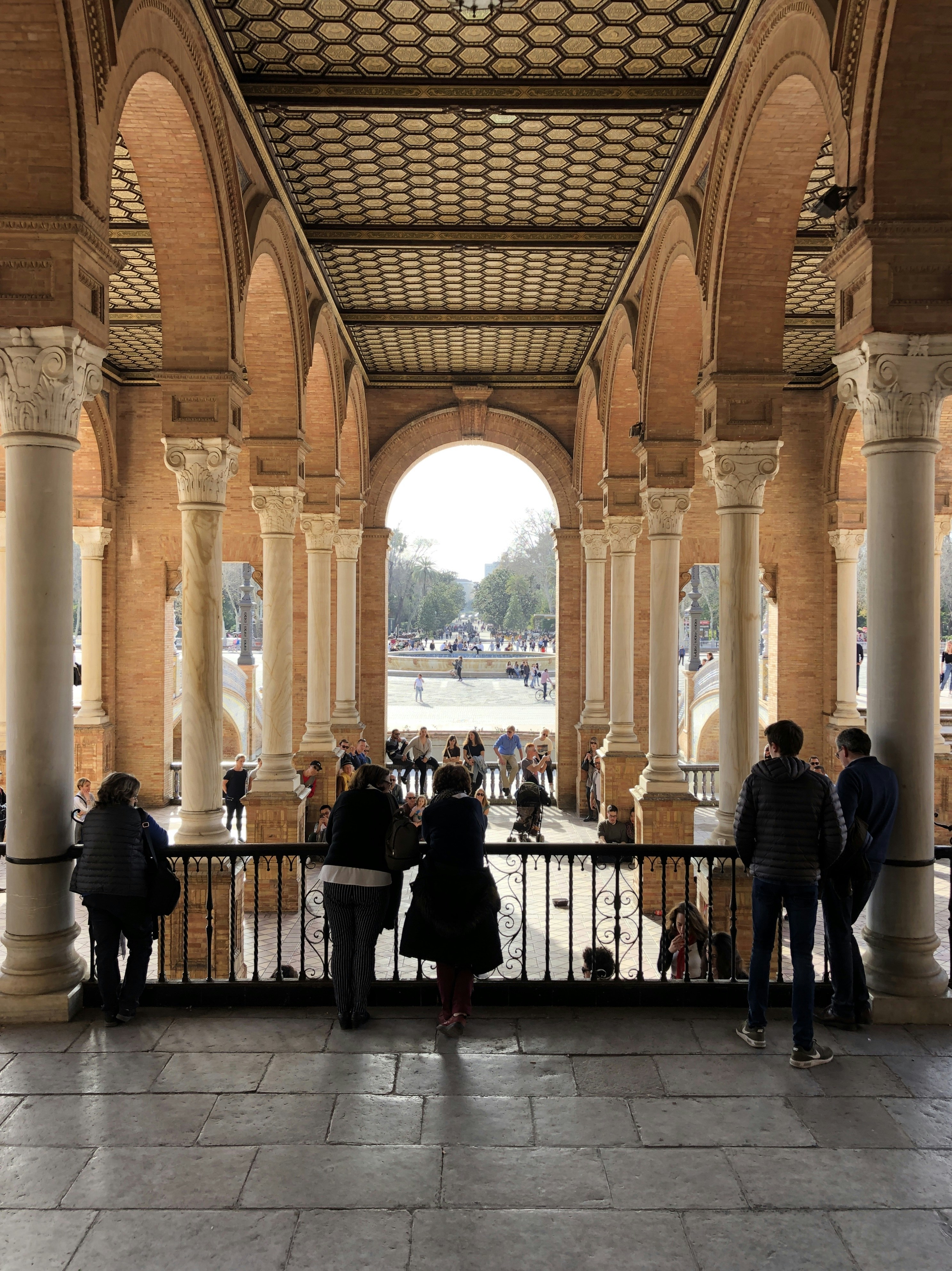 people standing and leaning on railings during daytime