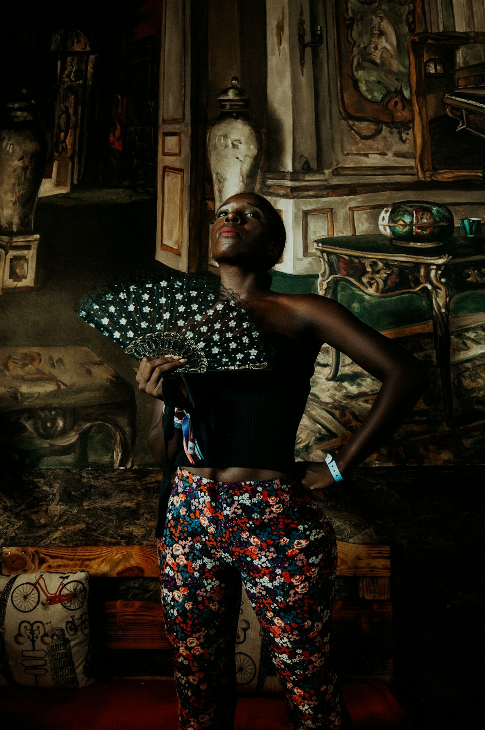 photo-shoot of woman looks up while holding hand fan